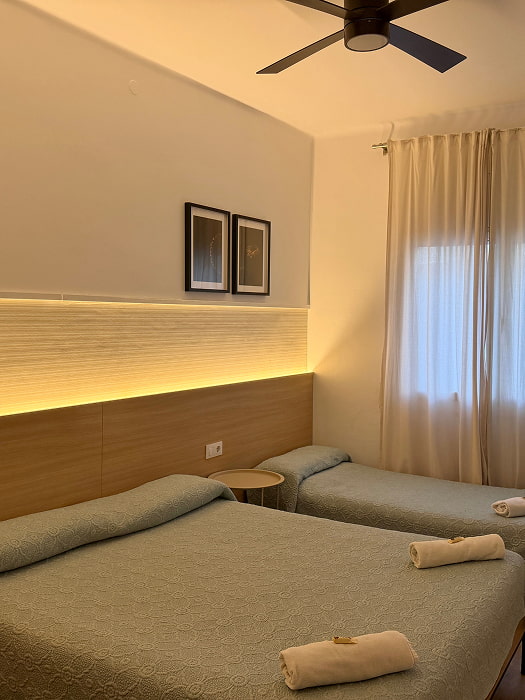 Habitación triple espaciosa con varias camas
